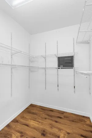 an empty room with a window and a fan