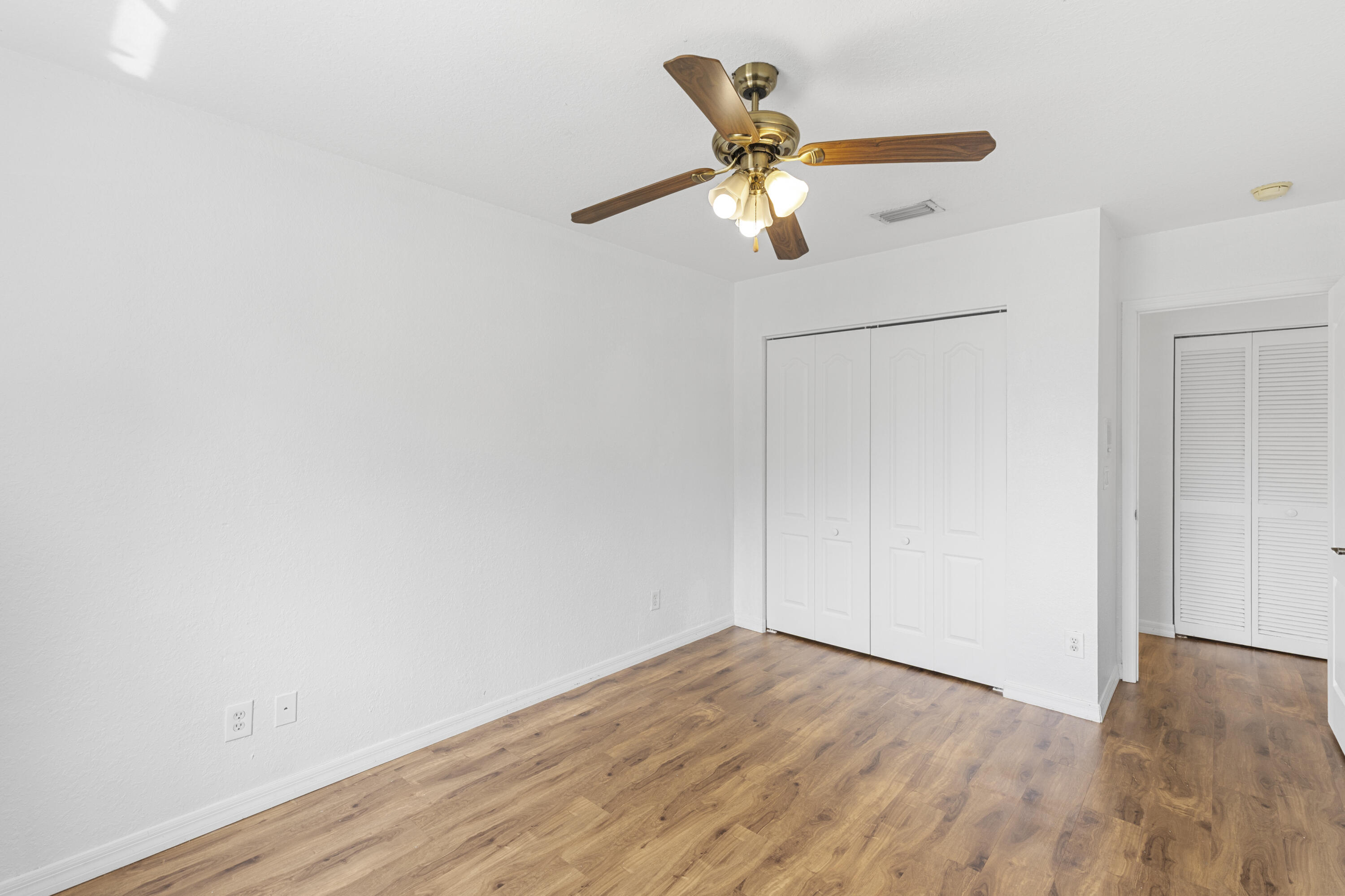 19389 Southwest 64th Street Pembroke Pines, FL 33332 - Photo 25 of 61 an empty room with wooden floor fan and windows