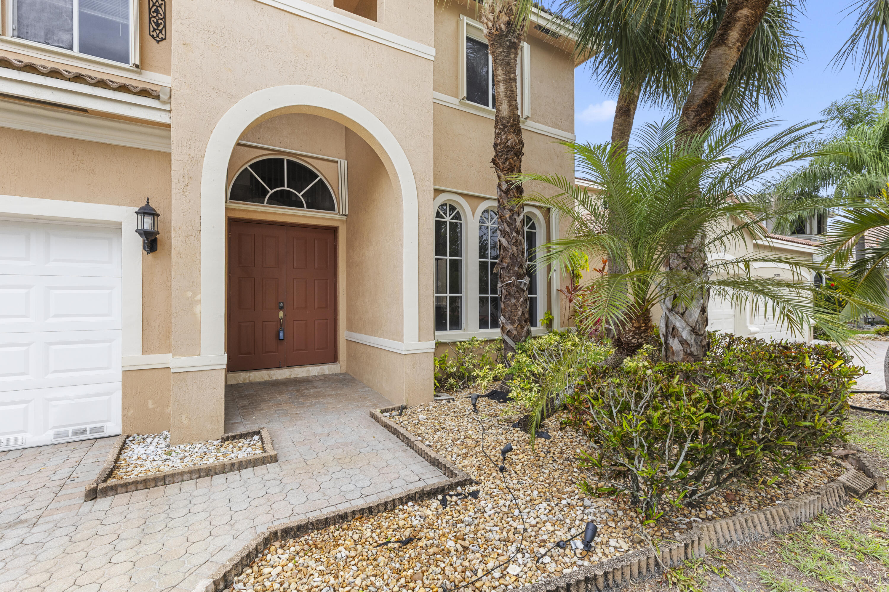 19389 Southwest 64th Street Pembroke Pines, FL 33332 - Photo 45 of 61 a front view of a house with a yard