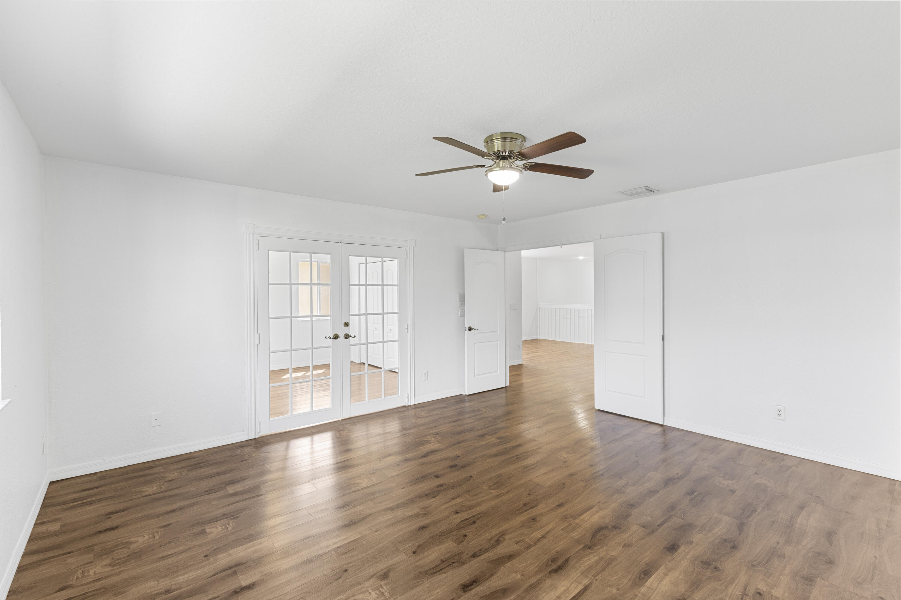 19389 Southwest 64th Street Pembroke Pines, FL 33332 - Photo 48 of 61 a view of an empty room with wooden floor and a window