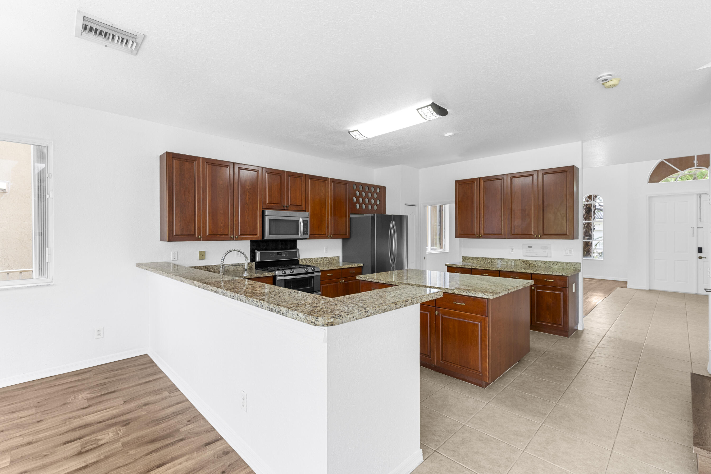 19389 Southwest 64th Street Pembroke Pines, FL 33332 - Photo 6 of 61 a kitchen with stainless steel appliances granite countertop a sink stove and microwave