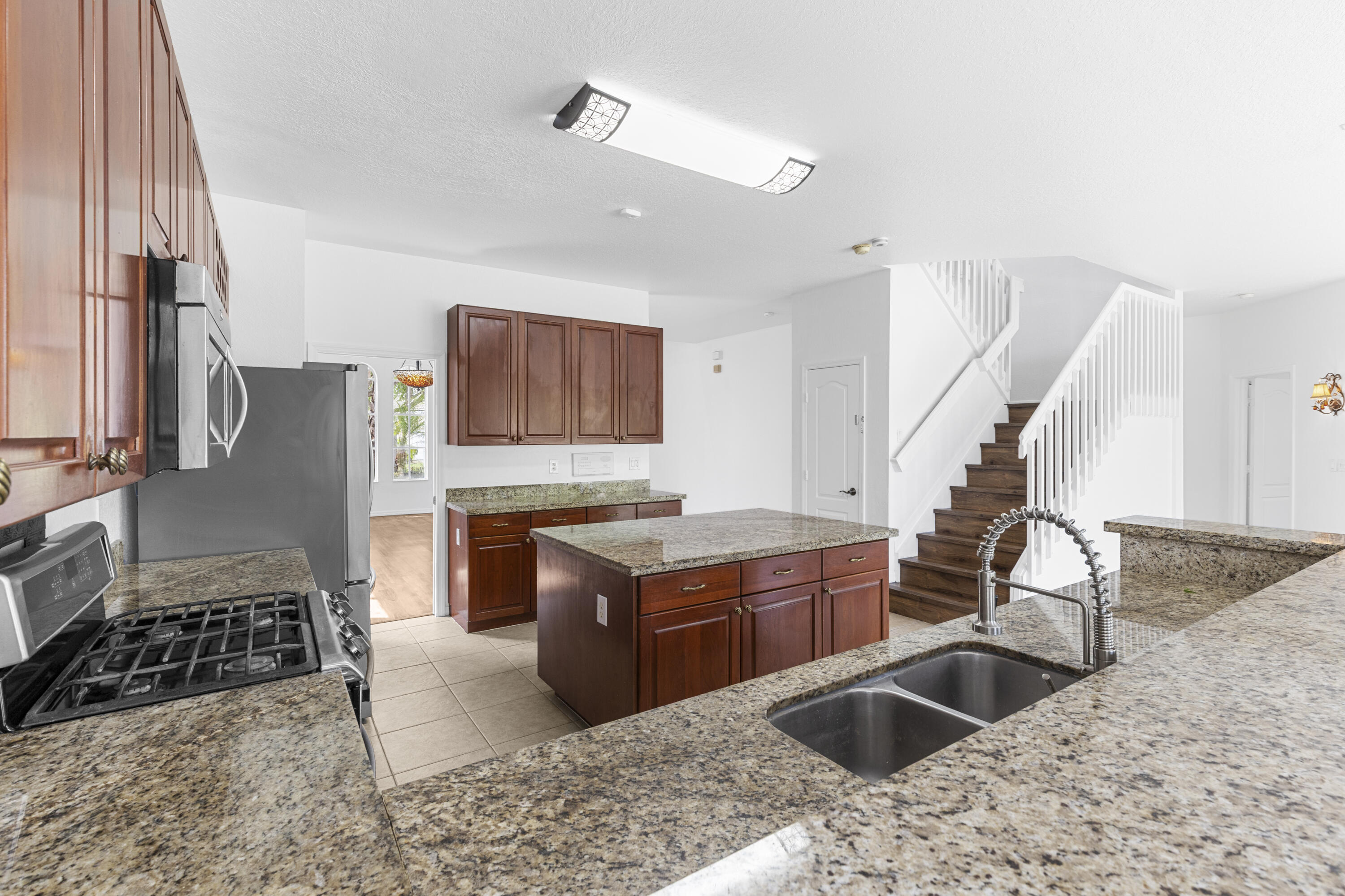19389 Southwest 64th Street Pembroke Pines, FL 33332 - Photo 7 of 61 a kitchen with a stove a sink and a refrigerator