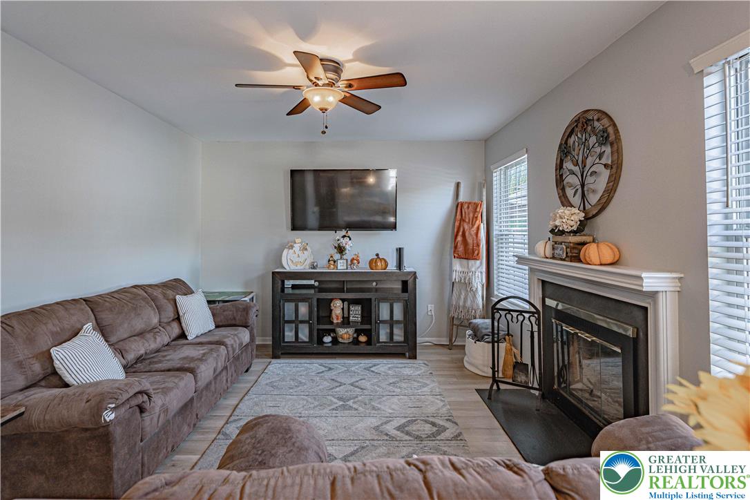 2389 Juniper Drive Coplay, PA 18037 - Photo 17 of 46 a living room with furniture a fireplace and a flat screen tv