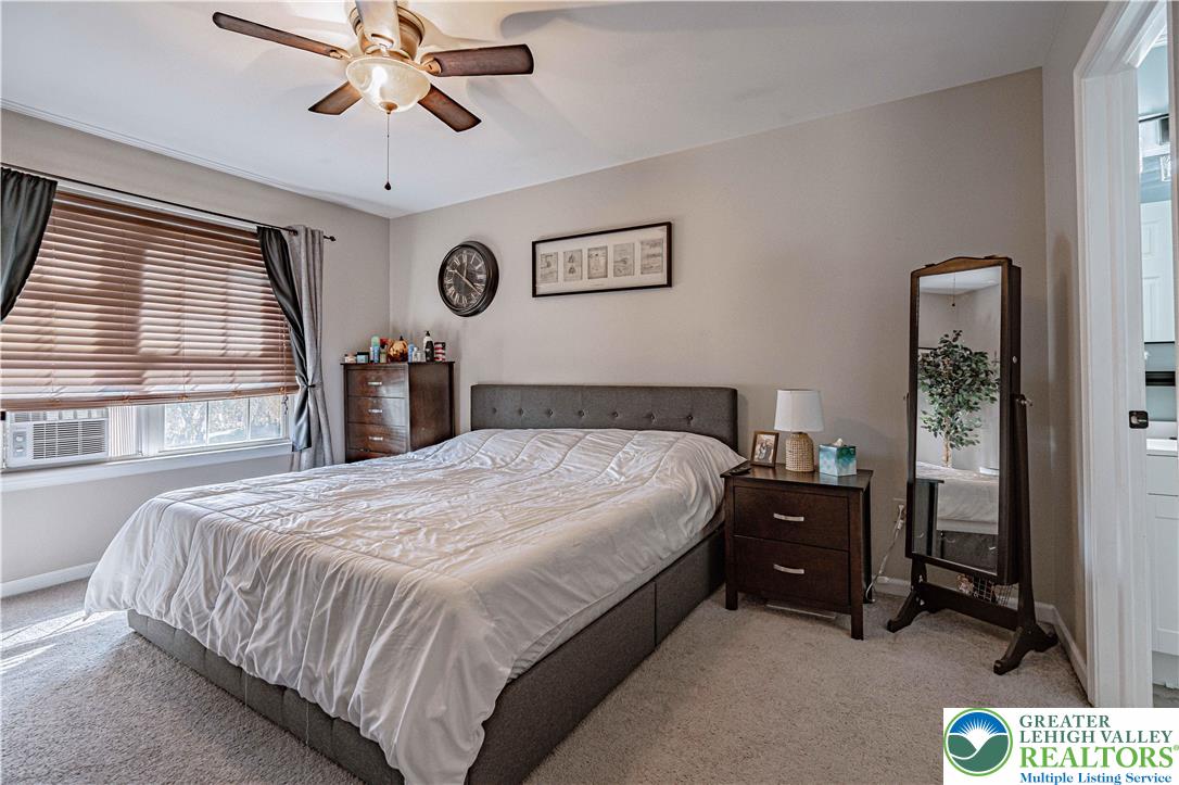 2389 Juniper Drive Coplay, PA 18037 - Photo 24 of 46 a bedroom with a bed and a chandelier