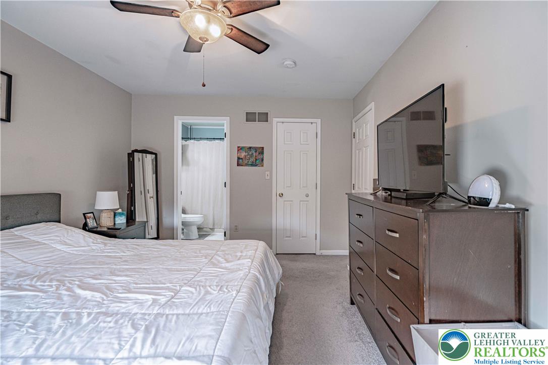 2389 Juniper Drive Coplay, PA 18037 - Photo 26 of 46 a bedroom with a bed and a flat tv screen on dresser