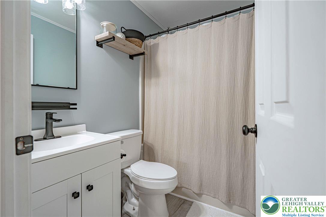 2389 Juniper Drive Coplay, PA 18037 - Photo 27 of 46 a bathroom with a sink a toilet and shower curtain
