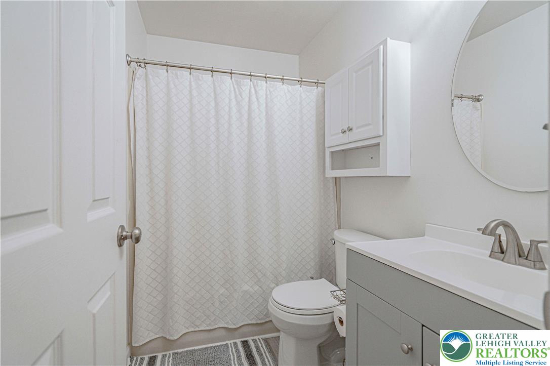 2389 Juniper Drive Coplay, PA 18037 - Photo 30 of 46 a bathroom with a sink a toilet and shower curtain