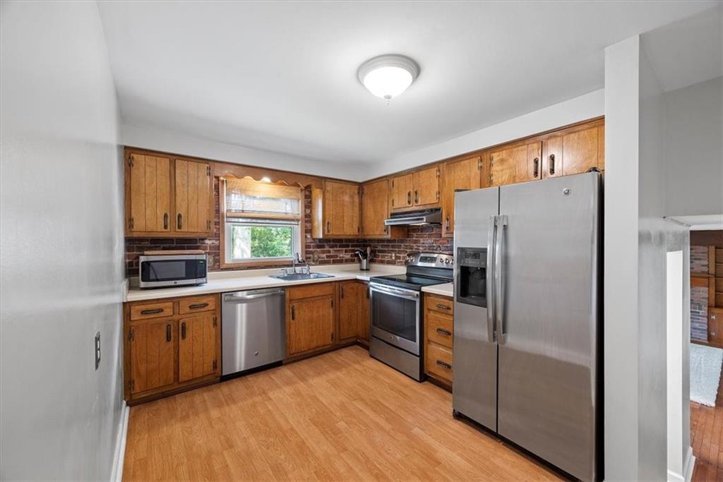 505 Hudderford Road Pittsburgh, PA 15237 - Photo 17 of 43 a kitchen with granite countertop stainless steel appliances a refrigerator sink and microwave