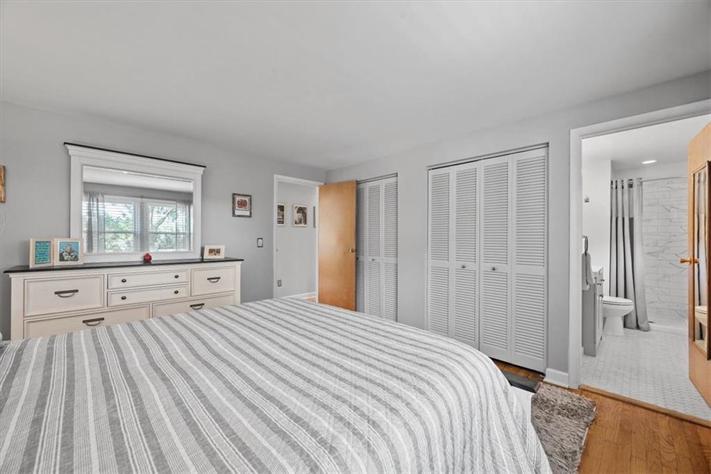 505 Hudderford Road Pittsburgh, PA 15237 - Photo 22 of 43 a bedroom with a large bed and a chandelier