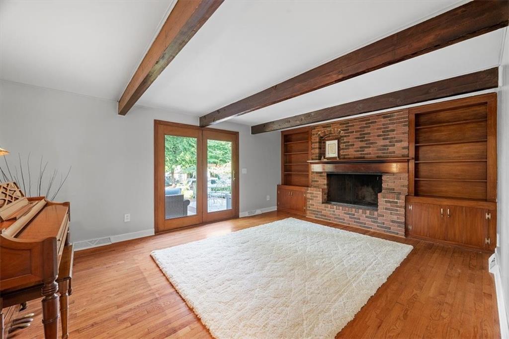 505 Hudderford Road Pittsburgh, PA 15237 - Photo 8 of 43 a view of empty room with wooden floor and fireplace