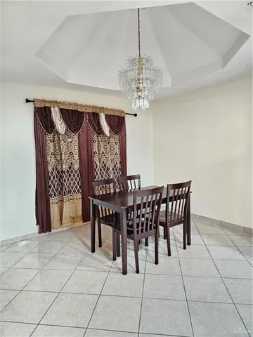 a view of a dining room with furniture and chandelier