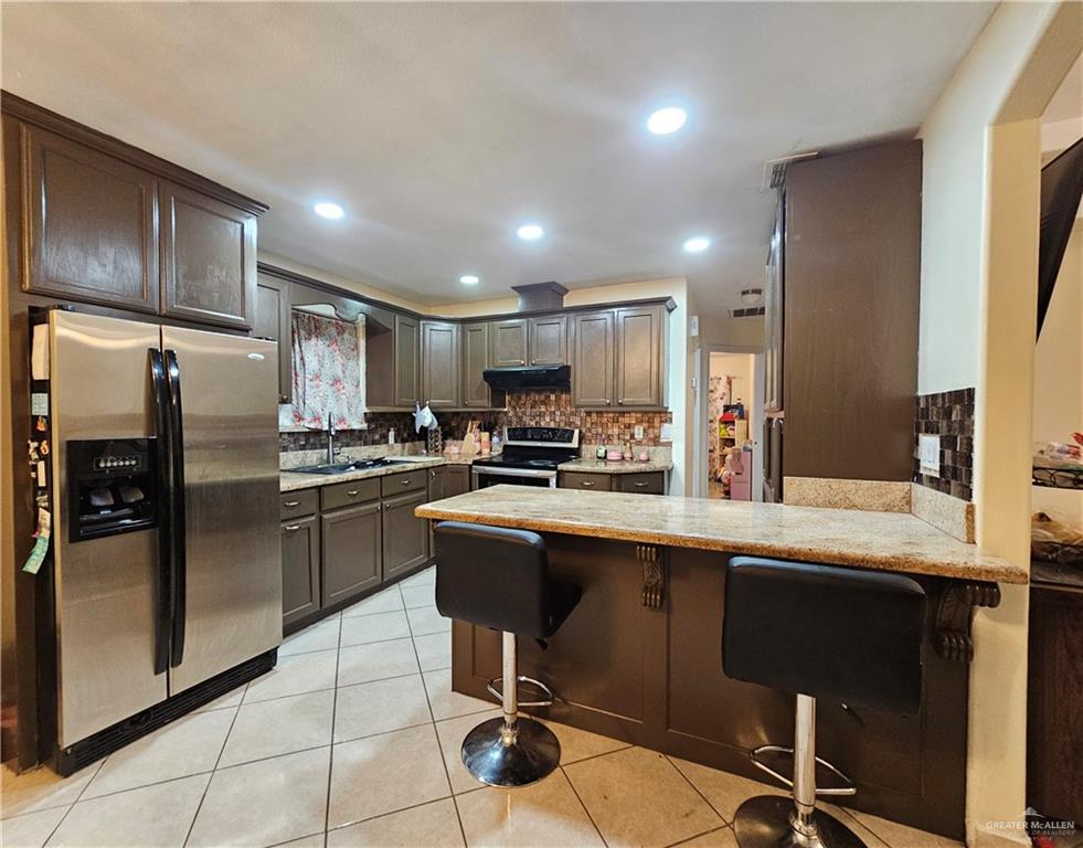 3702 Marla Drive Mission, TX 78572 - Photo 5 of 15 a kitchen with stainless steel appliances granite countertop a refrigerator sink and cabinets