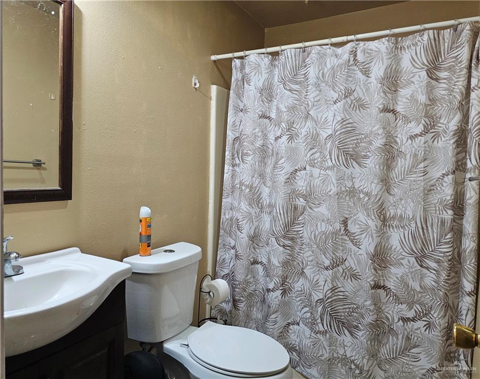 3702 Marla Drive Mission, TX 78572 - Photo 7 of 15 a white toilet sitting next to a bathroom sink