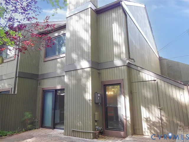 a view of a patio with couches and table and chairs and potted plants