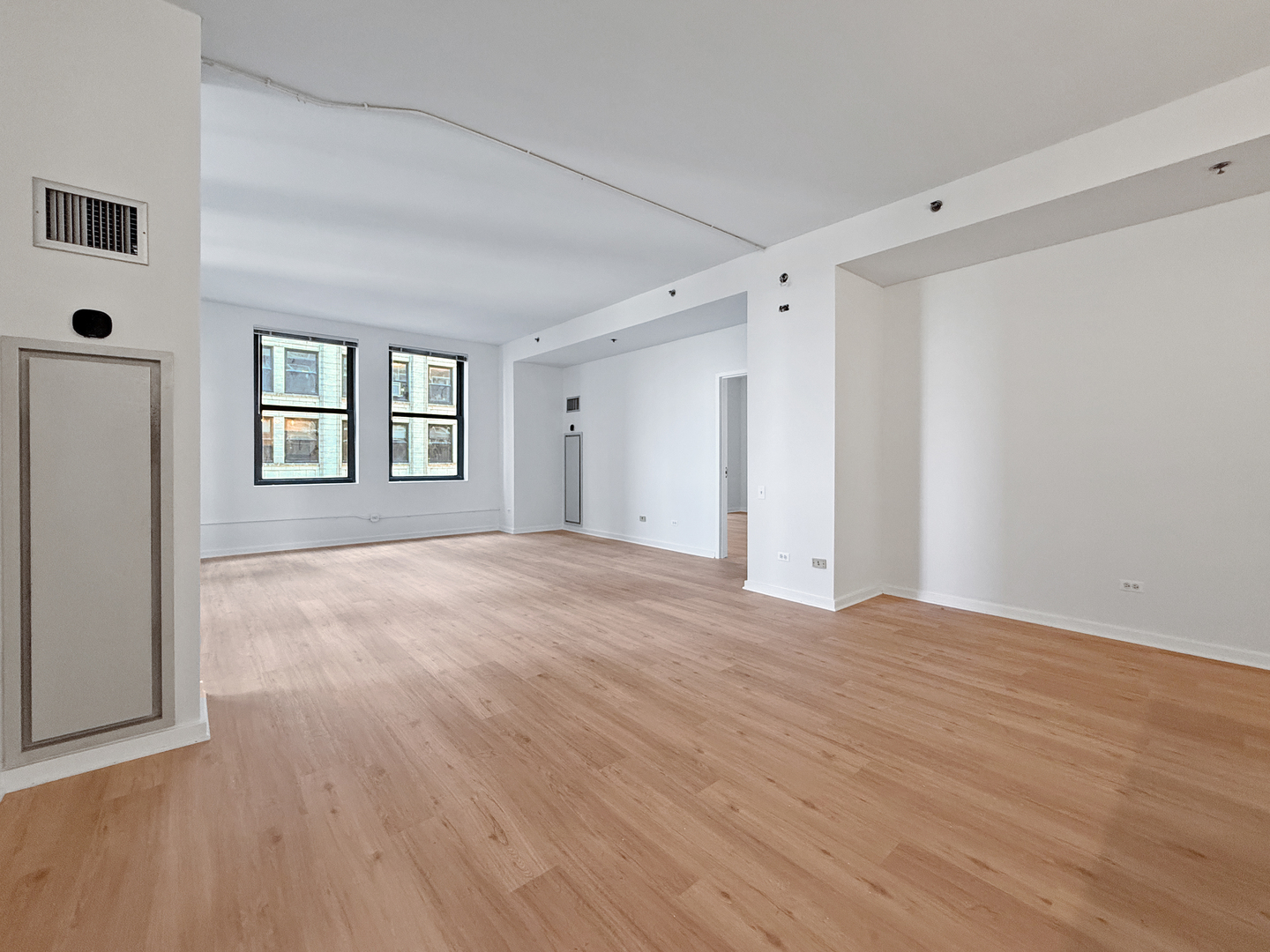 5 North Wabash Avenue, Unit 1201 Chicago, IL 60602 - Photo 11 of 33 a view of an empty room with wooden floor and a window