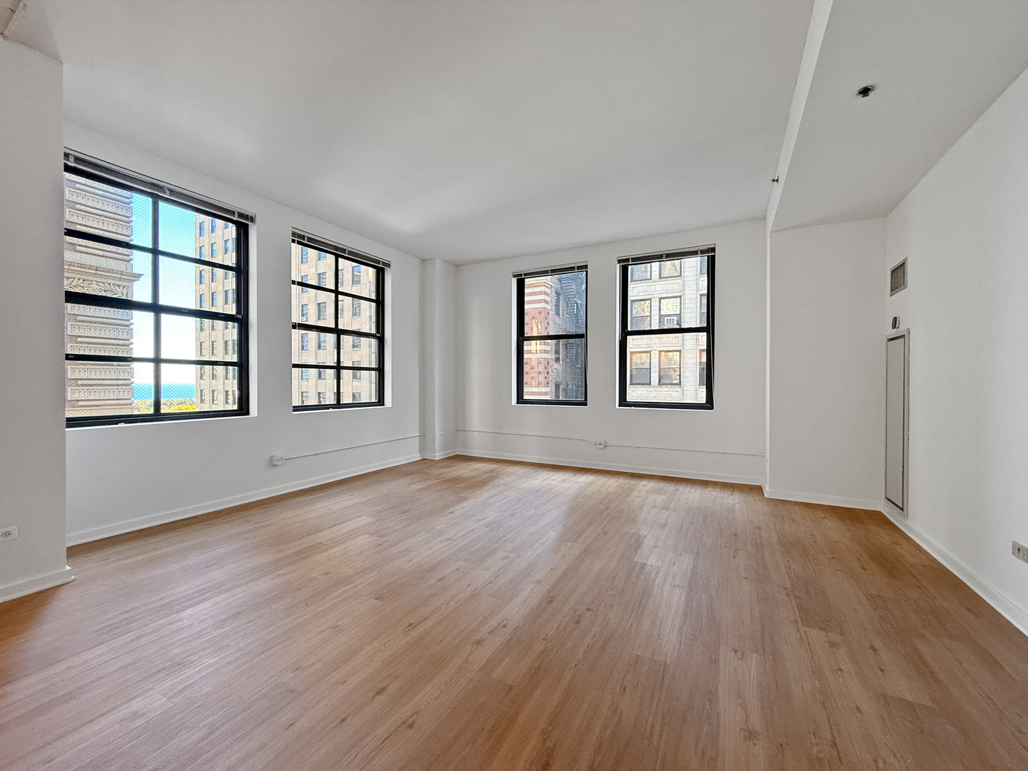 5 North Wabash Avenue, Unit 1201 Chicago, IL 60602 - Photo 12 of 33 an empty room with wooden floor and windows