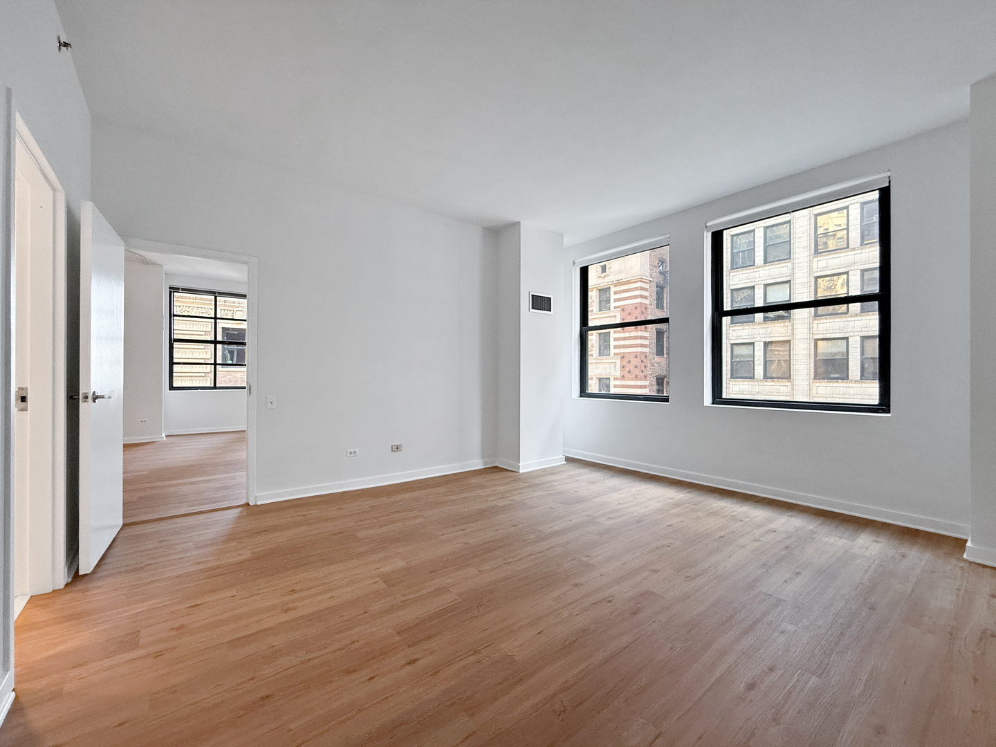 5 North Wabash Avenue, Unit 1201 Chicago, IL 60602 - Photo 20 of 33 a view of an empty room with wooden floor and windows
