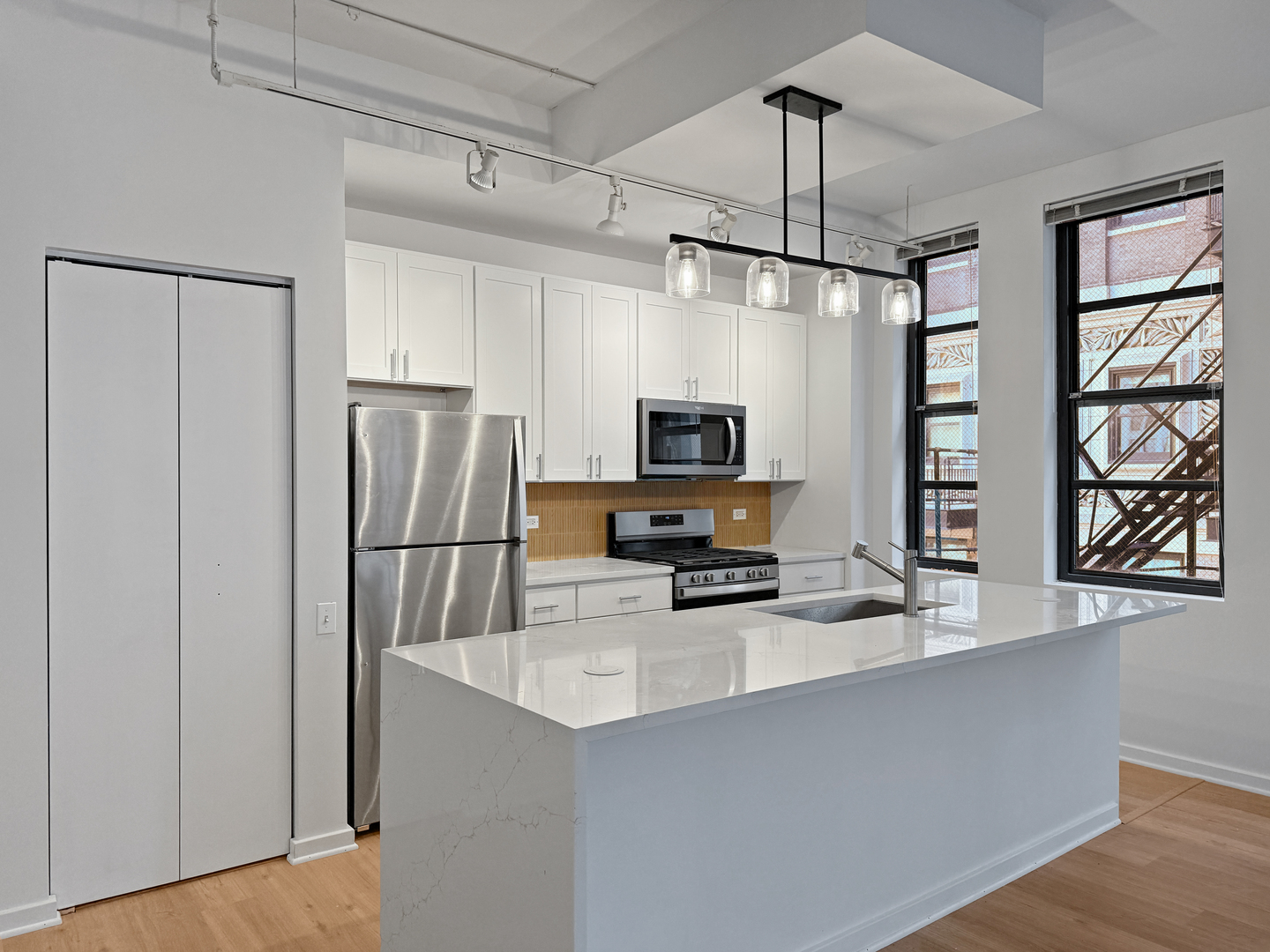 5 North Wabash Avenue, Unit 1201 Chicago, IL 60602 - Photo 2 of 33 a kitchen with stainless steel appliances a refrigerator sink and microwave
