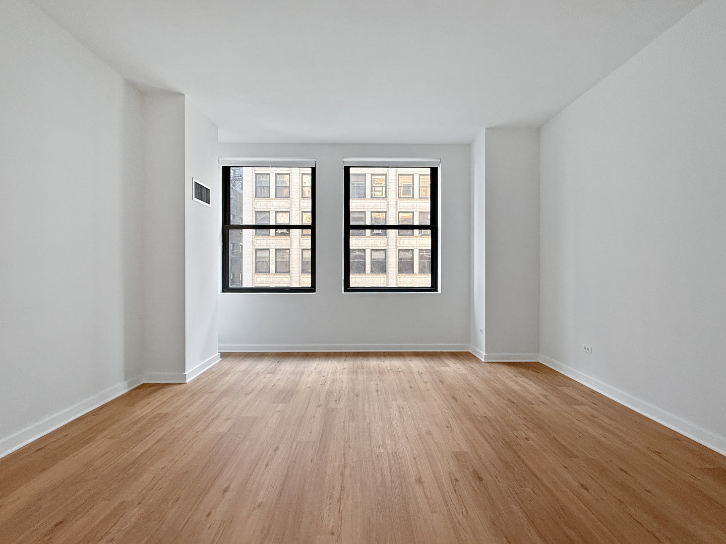 5 North Wabash Avenue, Unit 1201 Chicago, IL 60602 - Photo 21 of 33 an empty room with wooden floor and windows