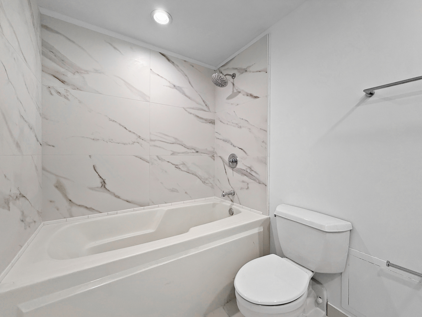 5 North Wabash Avenue, Unit 1201 Chicago, IL 60602 - Photo 25 of 33 a white toilet and tub sitting next to a bathroom sink