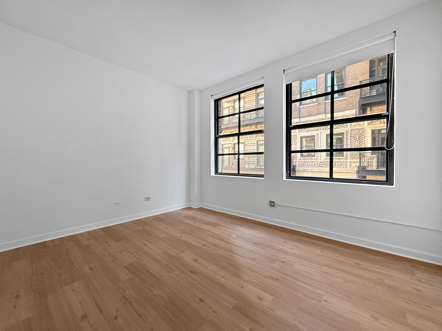 5 North Wabash Avenue, Unit 1201 Chicago, IL 60602 - Photo 28 of 33 an empty room with wooden floor and windows