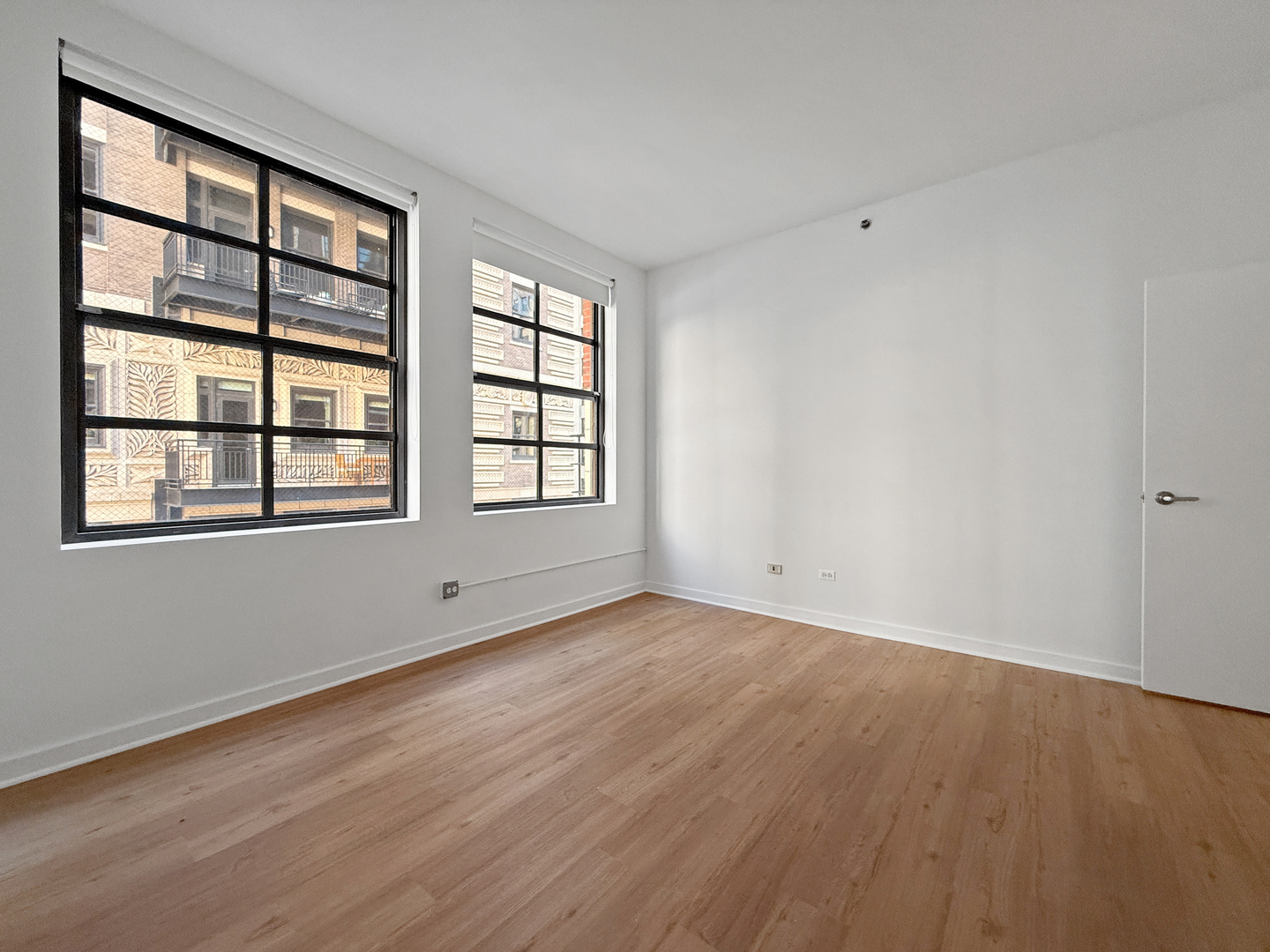 5 North Wabash Avenue, Unit 1201 Chicago, IL 60602 - Photo 29 of 33 an empty room with wooden floor and windows