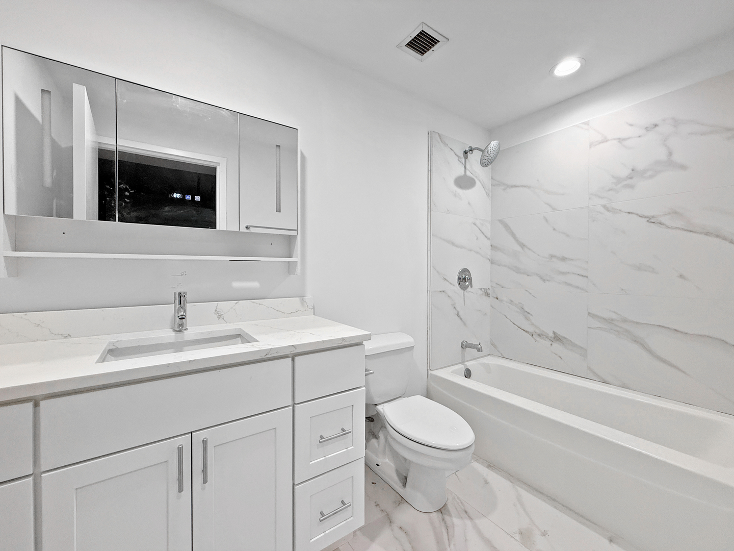 5 North Wabash Avenue, Unit 1201 Chicago, IL 60602 - Photo 31 of 33 a bathroom with a toilet a sink a mirror a bathtub and vanity