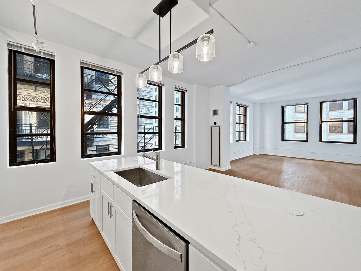 5 North Wabash Avenue, Unit 1201 Chicago, IL 60602 - Photo 5 of 33 a kitchen with granite countertop a stove and a sink