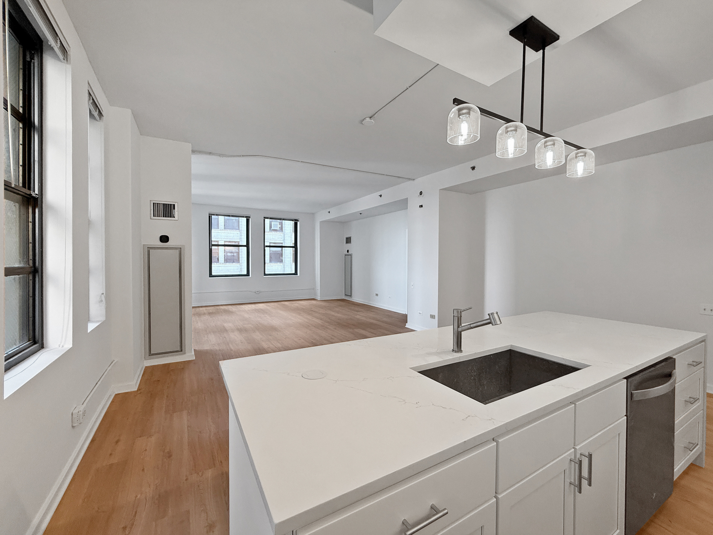 5 North Wabash Avenue, Unit 1201 Chicago, IL 60602 - Photo 8 of 33 a kitchen that has a lot of cabinets and wooden floor