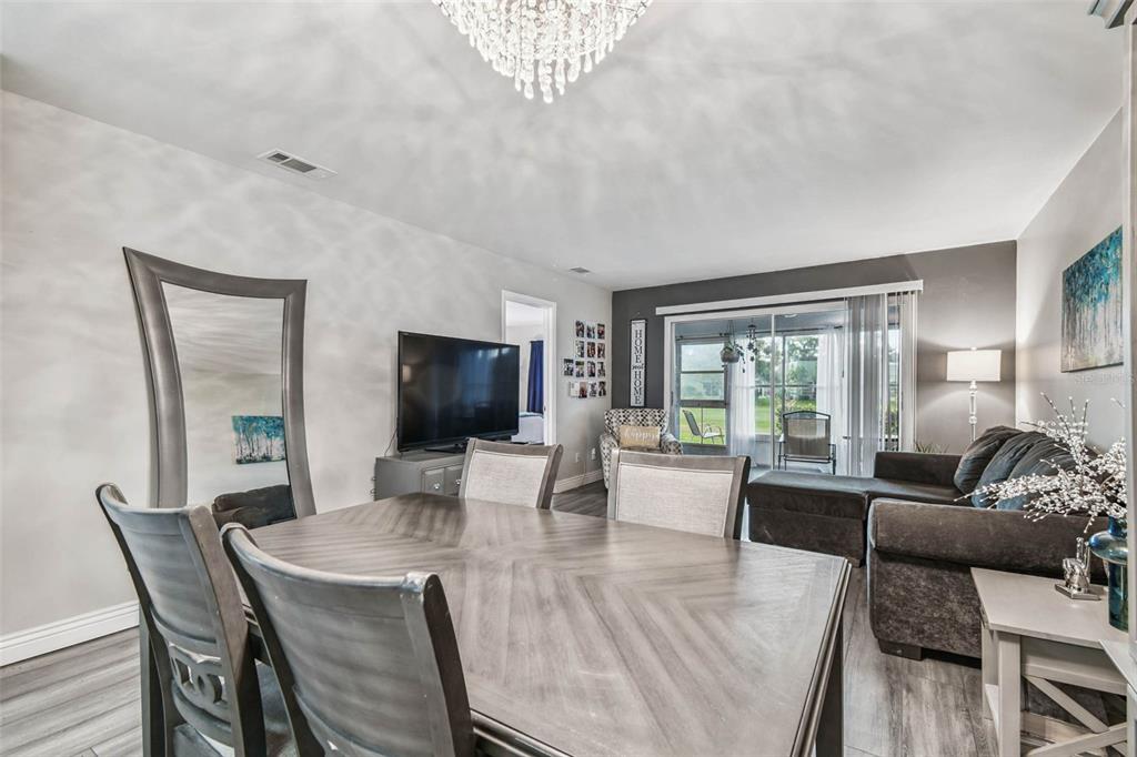 9613 Midiron Court, Unit 39A New Port Richey, FL 34655 - Photo 11 of 76 a living room with furniture a flat screen tv and a large window