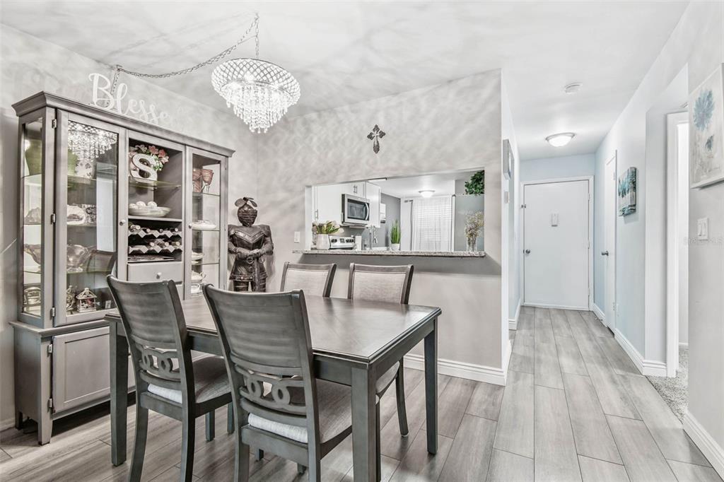 9613 Midiron Court, Unit 39A New Port Richey, FL 34655 - Photo 13 of 76 a view of a dining room with furniture and a chandelier