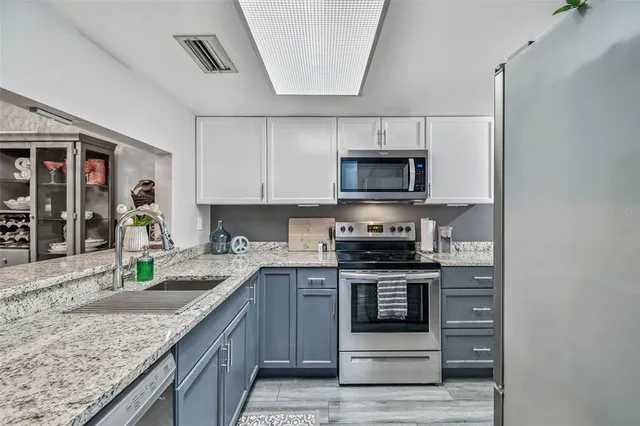 a bedroom with a large bed and a flat tv screen
