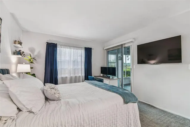 a bathroom with a sink a toilet a mirror and shower curtain