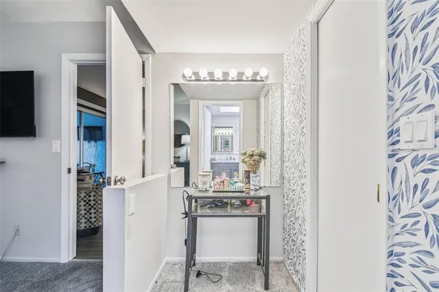 a view of hallway with furniture and a potted plant