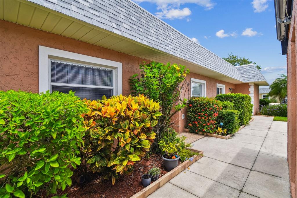 9613 Midiron Court, Unit 39A New Port Richey, FL 34655 - Photo 3 of 76 a front view of a house with a garden