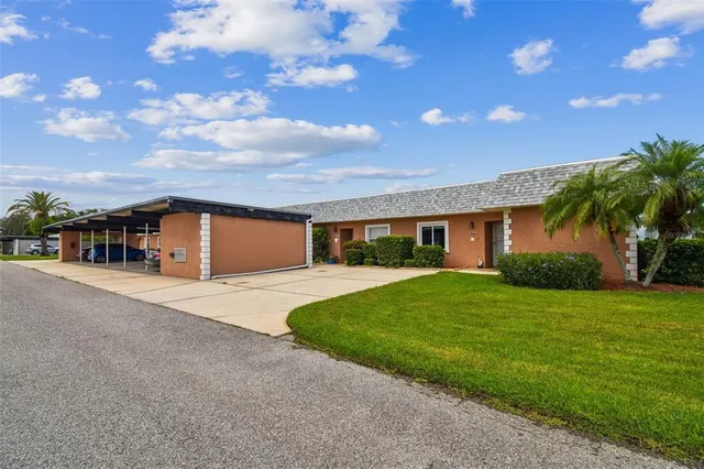 a view of a hallway with wooden floor and furniture