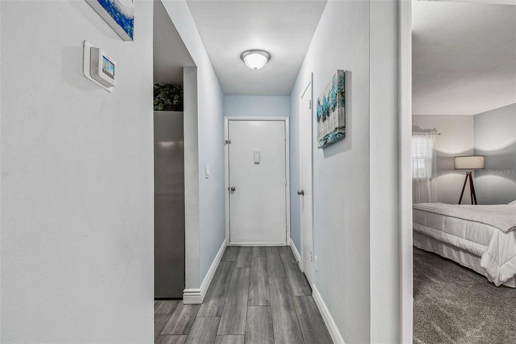 9613 Midiron Court, Unit 39A New Port Richey, FL 34655 - Photo 9 of 76 a view of a hallway with wooden floor and furniture