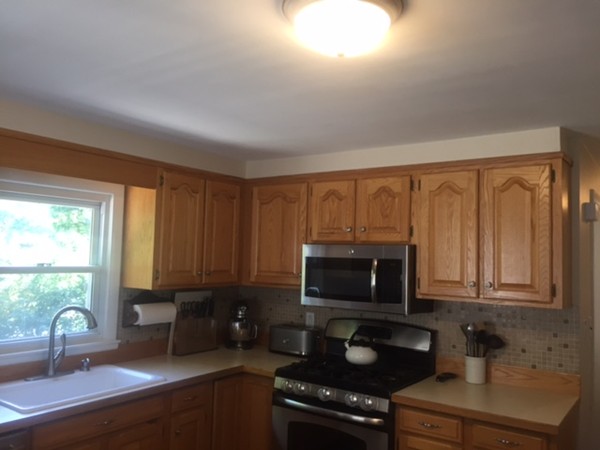 31 Spring View Drive Lynn, MA 01904 - Photo 5 of 12 a kitchen with granite countertop a stove a sink and a microwave