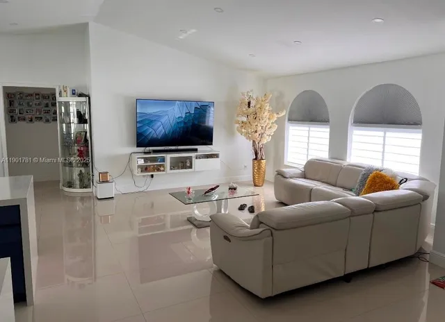 a living room with furniture and a flat screen tv