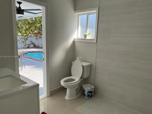 a white toilet sitting next to a bathroom sink