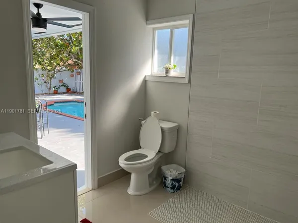 a white toilet sitting next to a bathroom sink