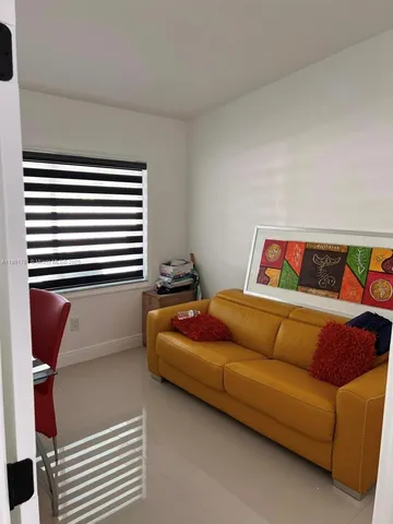 a bedroom with a bed and a book shelf