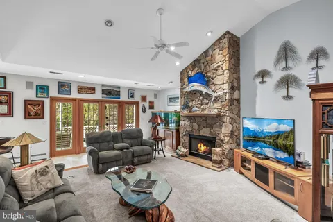 a living room with furniture a flat screen tv and a fireplace