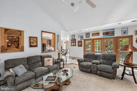 a living room with furniture and large window with wooden floor