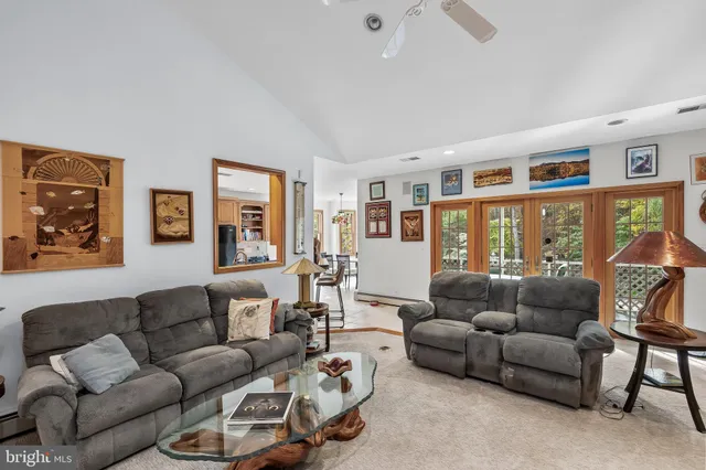 a living room with furniture and large window with wooden floor
