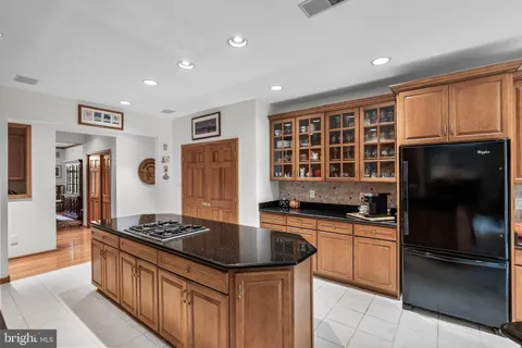 a kitchen with granite countertop stainless steel appliances and wooden cabinets