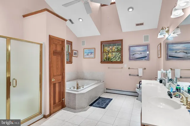 a bathroom with a tub sink and mirror