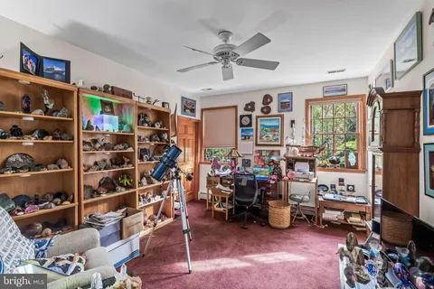 a view of a livingroom with workspace and a window