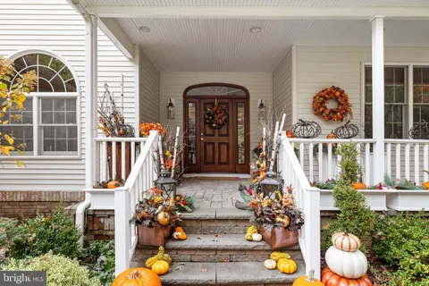 a front view of a house with outdoor seating