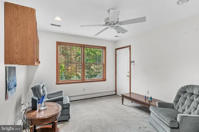 a view of a livingroom with furniture and a window